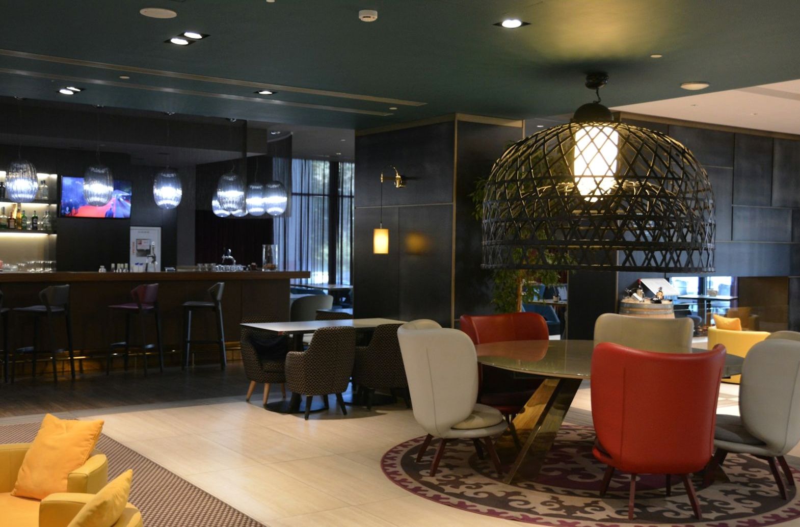 Contemporary lounge with colourful seating and soft lighting